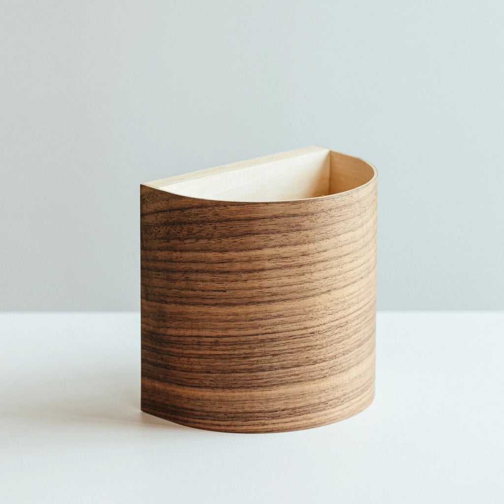Battery operated walnut wall sconce on a wall