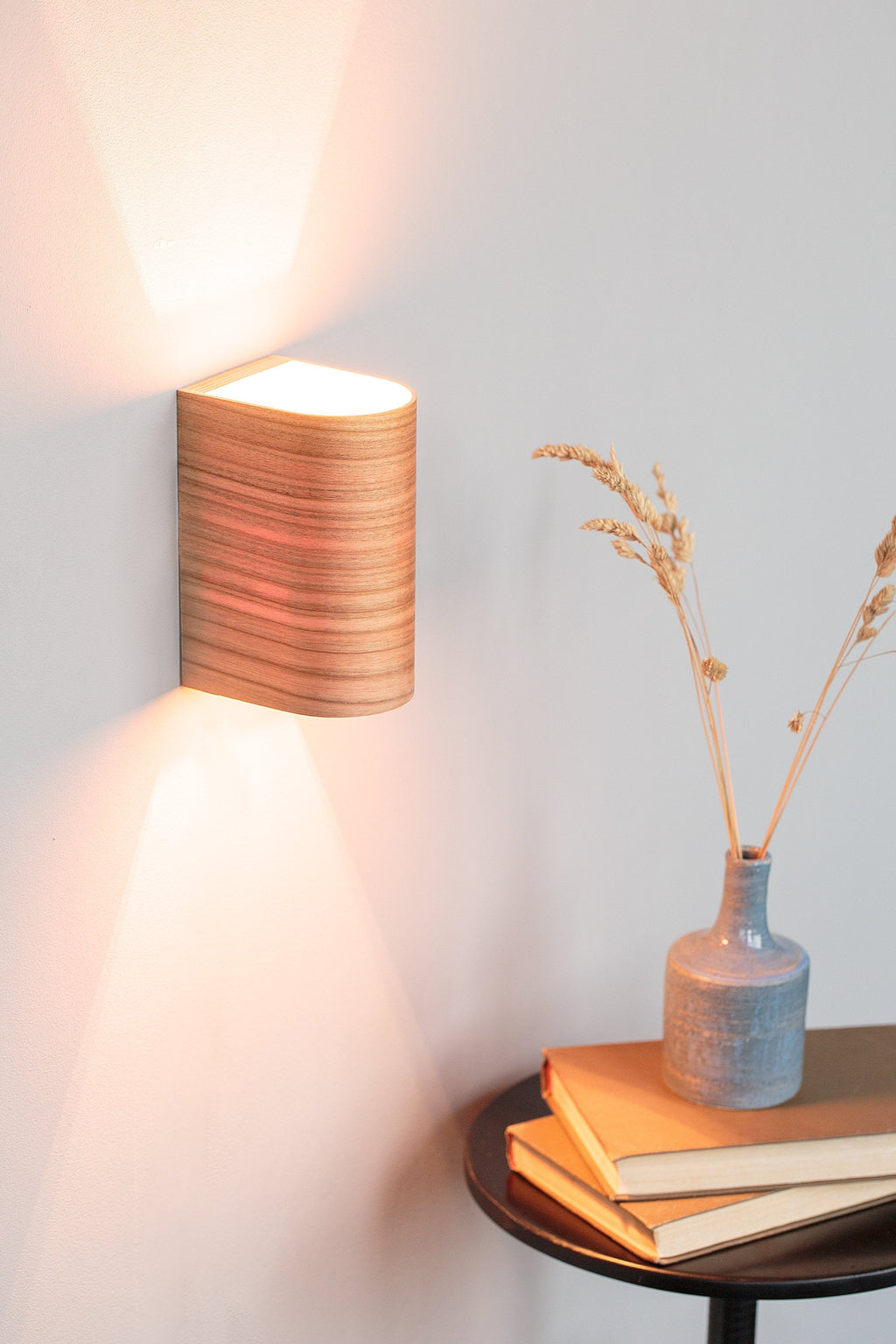 Cherry wood wall sconce mounted on a bedroom wall