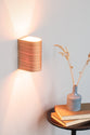 Cherry wood wall sconce mounted on a bedroom wall