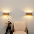 Set of 2 walnut wall sconces mounted on a wall