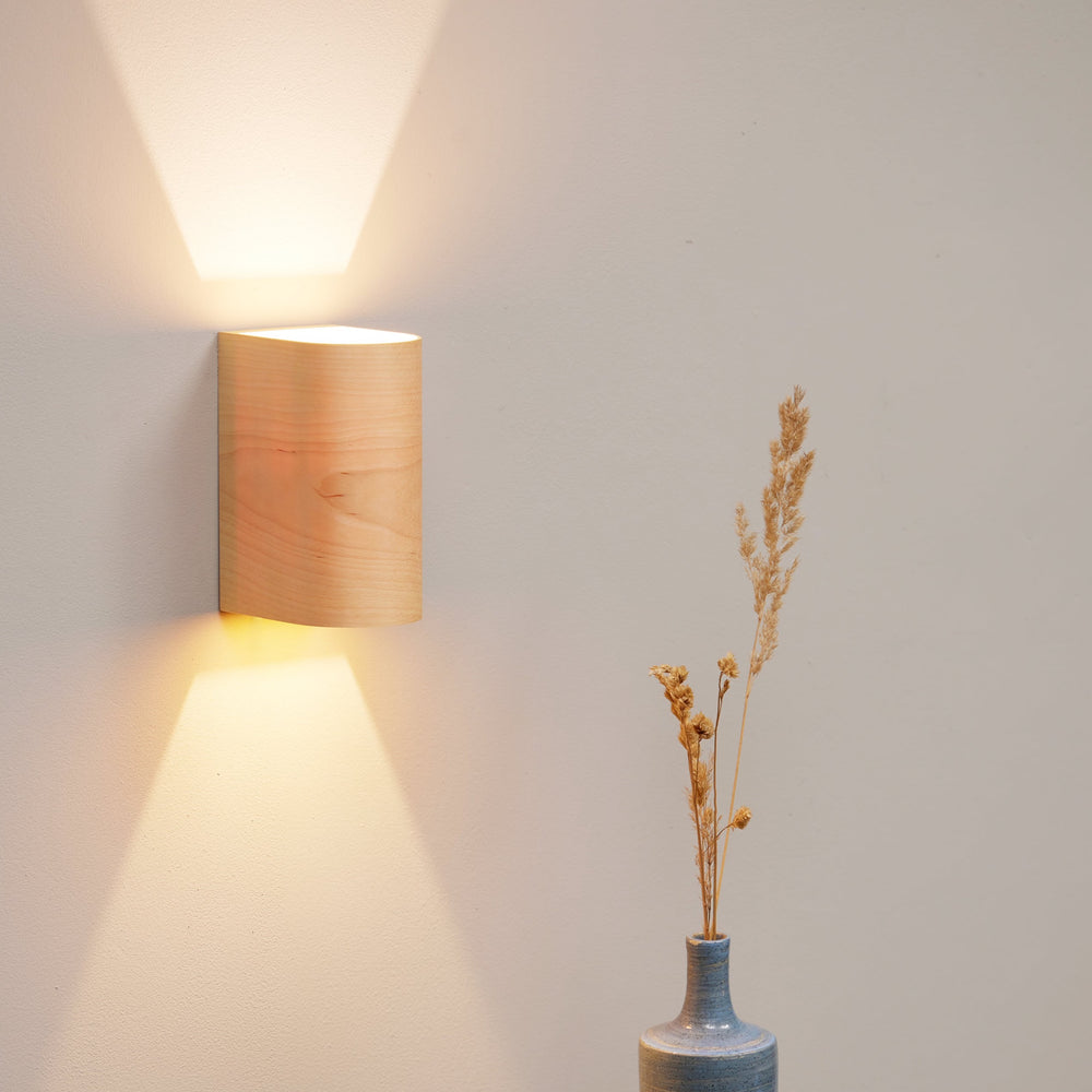 Birch wood wall sconce mounted on a nursery wall