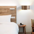 Walnut 3-light wall sconce mounted on a wall
