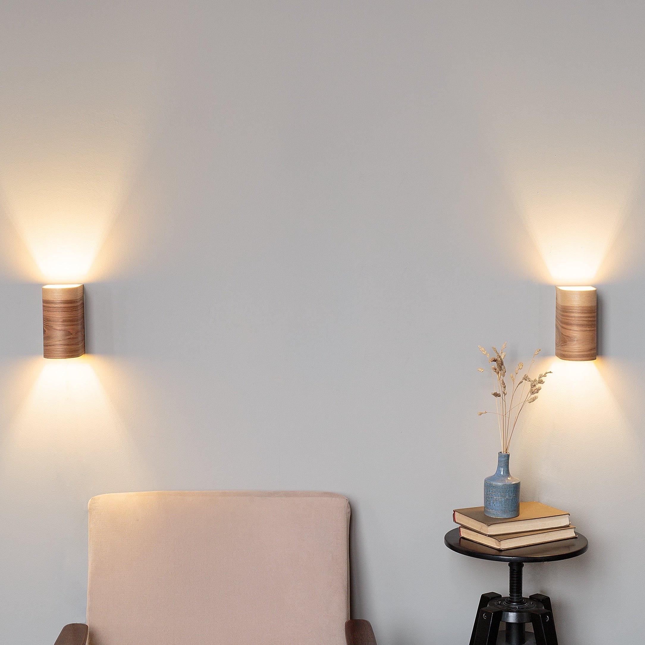 Set of 2 ash wall sconces on a wall