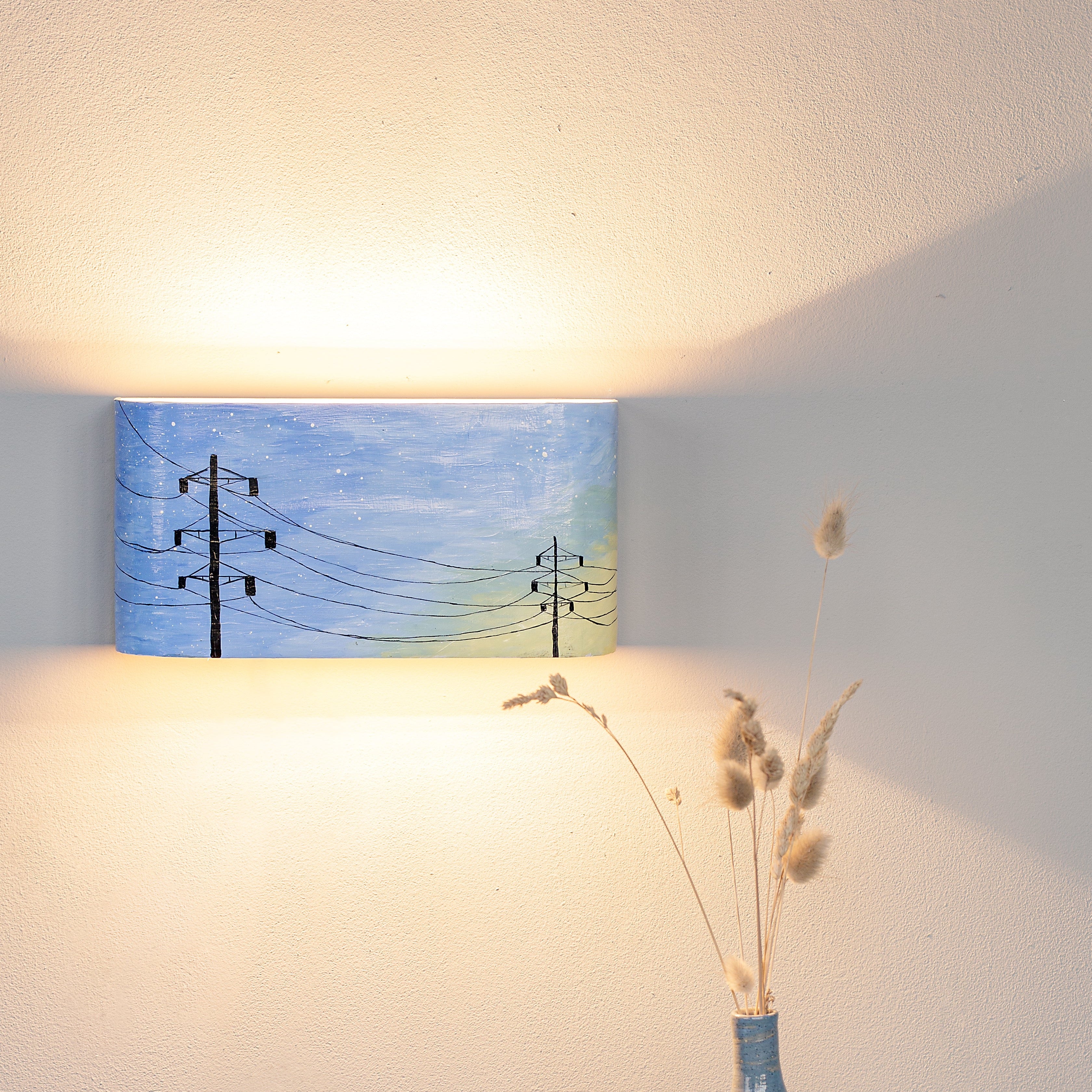 Compact hand-painted accent light mounted on a wall
