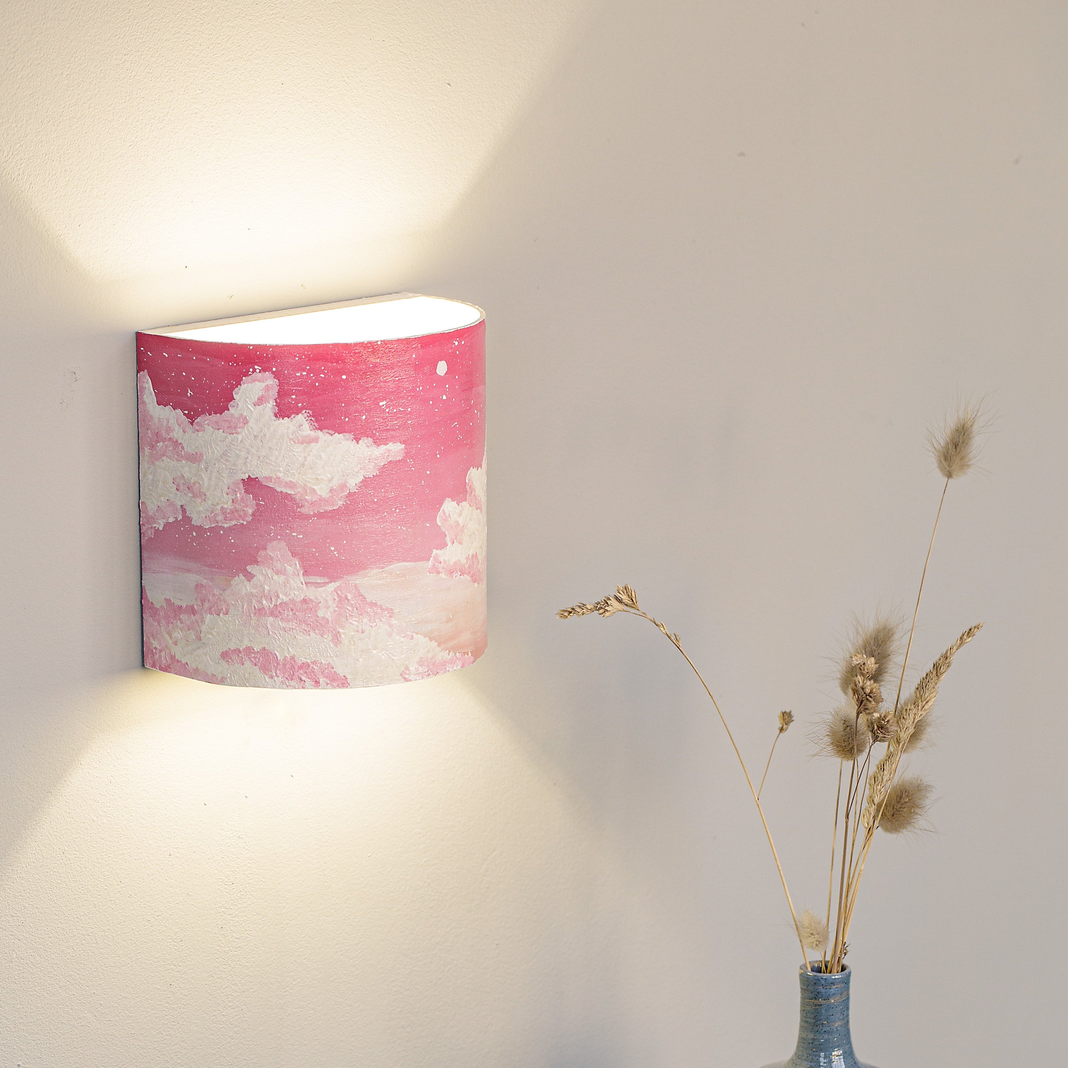 Hand-painted nursery wall sconce mounted in a kids room