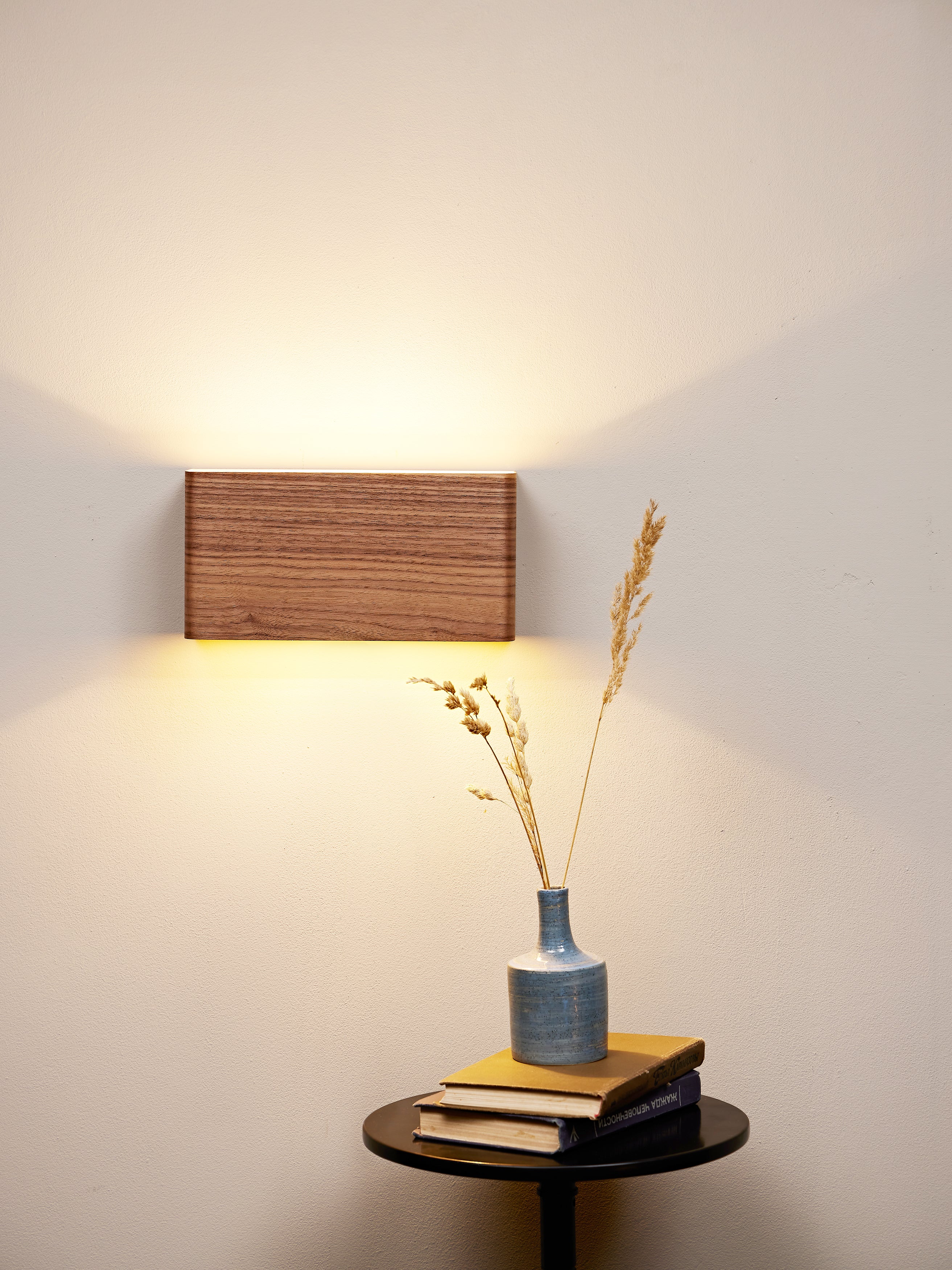 Matching walnut wall sconces, front view