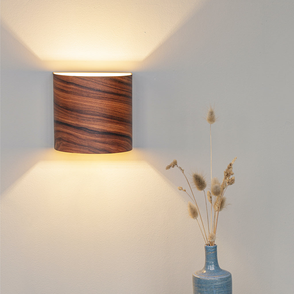 Rosewood wall lamp mounted in a living room