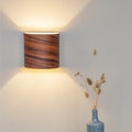 Rosewood wall lamp mounted in a living room