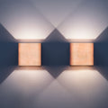 Pair of birch bedside wall lamps mounted by a bed