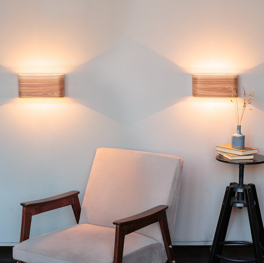 Set of 2 ash wall sconces mounted either side of a bed