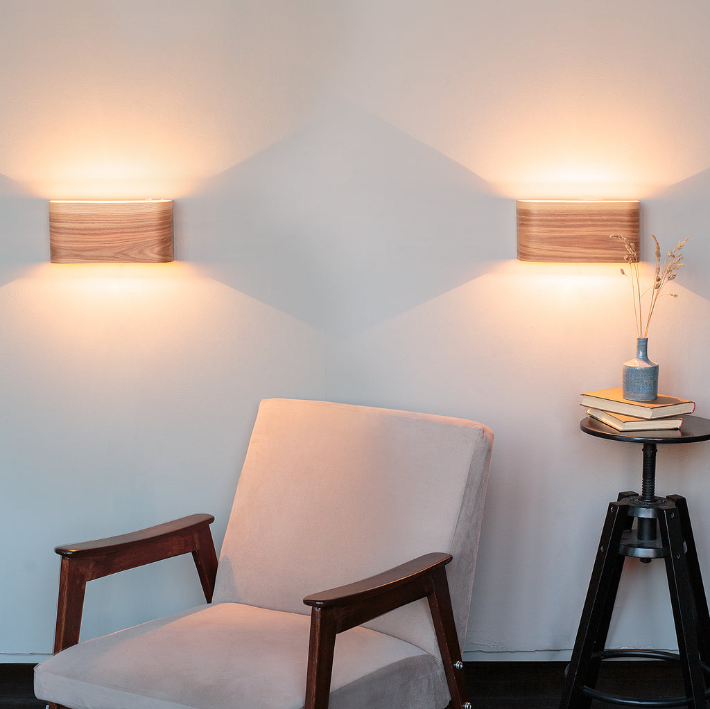Set of 2 ash wall sconces mounted either side of a bed
