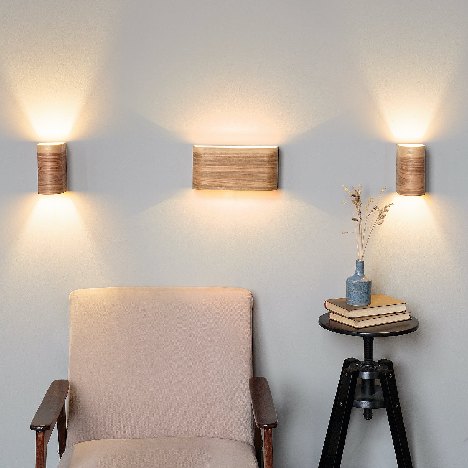 Set of 3 wood wall sconces mounted along a hallway