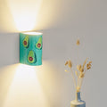 Hand-painted kitchen wall sconce mounted on a wall