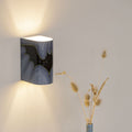 Hand-painted decorative wall sconce mounted on a wall