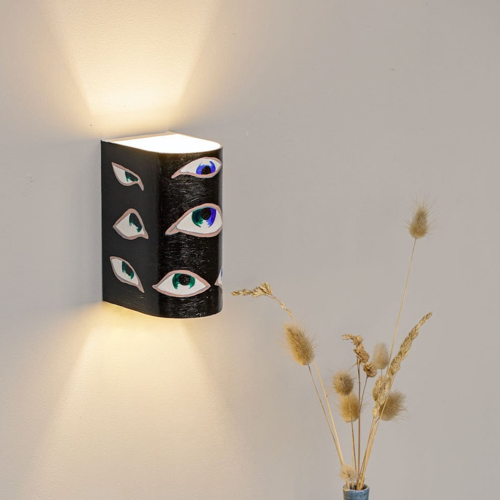 Colorful hand-painted decorative wall sconce mounted on a wall