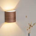 Walnut hallway wall sconce mounted in a corridor