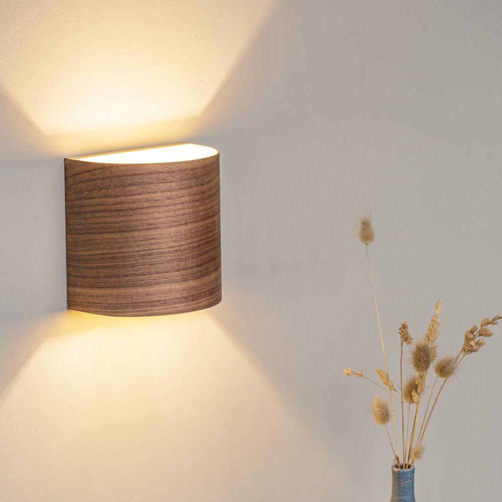 Walnut hallway wall sconce mounted in a corridor