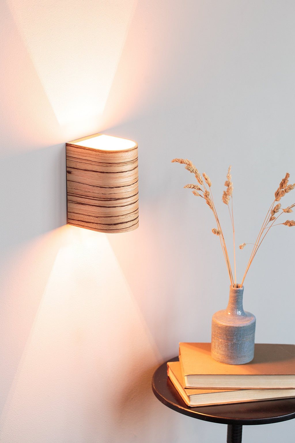 Zebrano wood wall sconce mounted on a wall