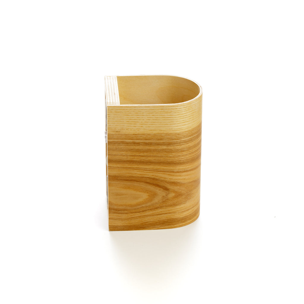Ash wood wall sconce lit at night