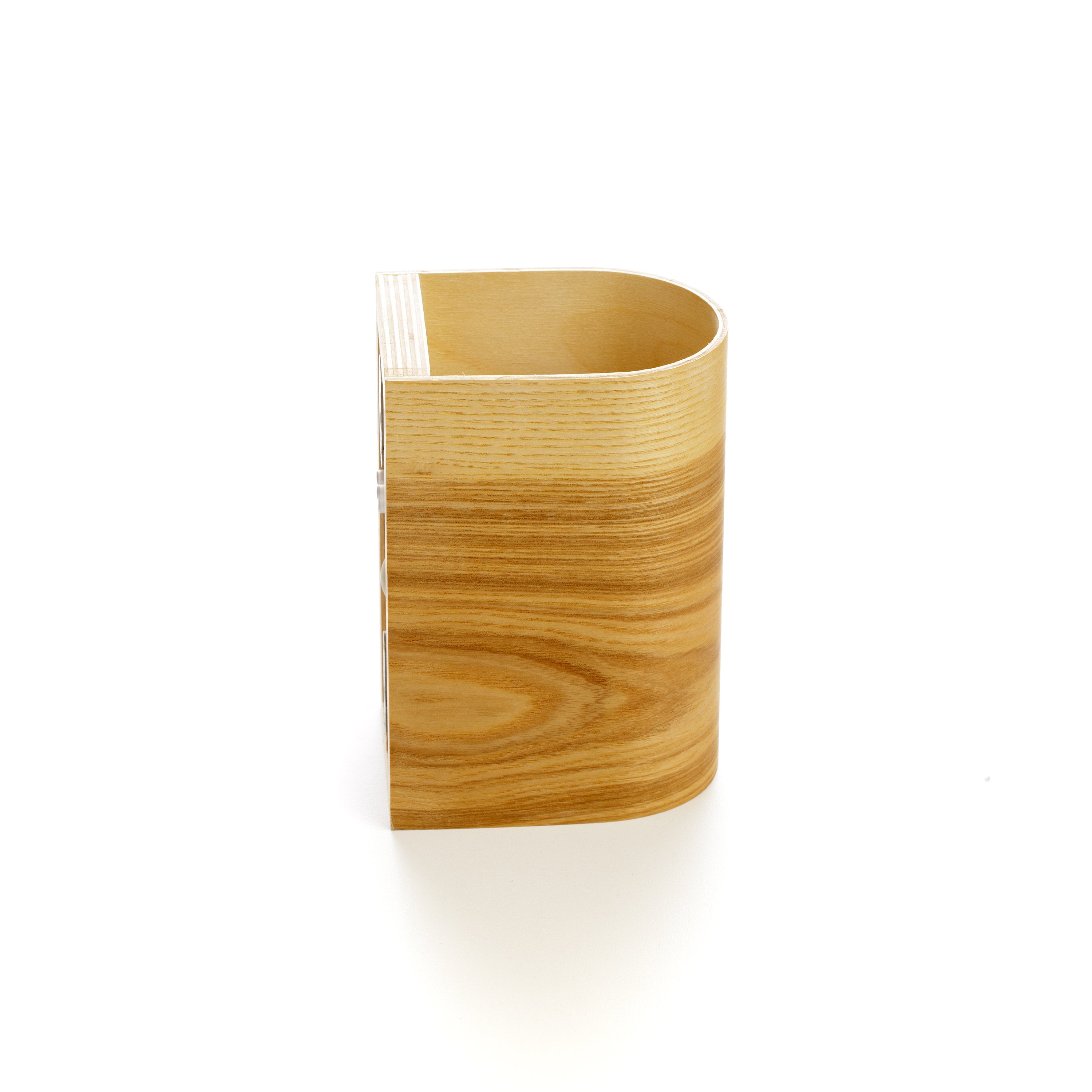 Ash wood wall sconce lit at night